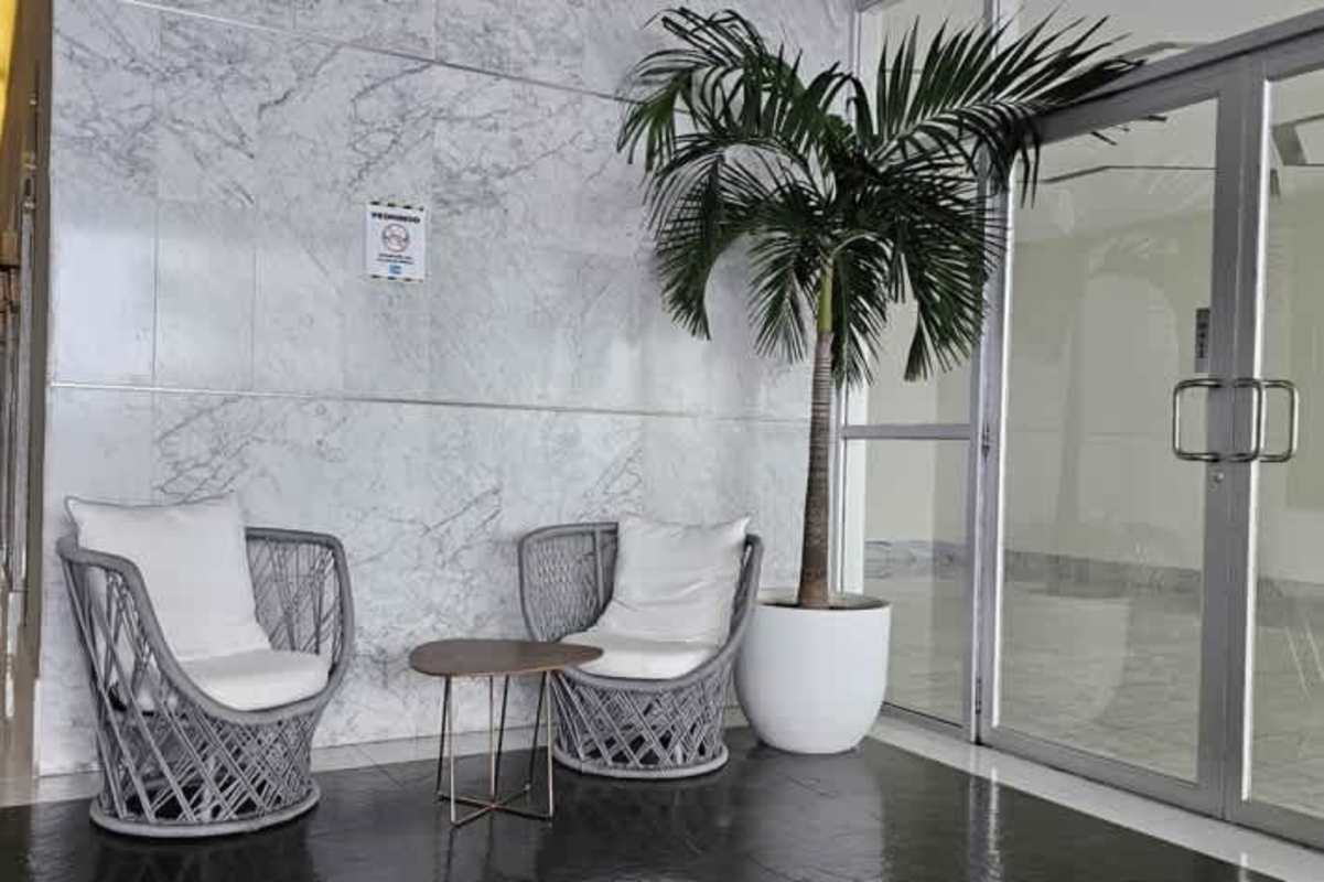 Double height modern lobby with marble accents and concierge at PH Waters on the Bay in Panama