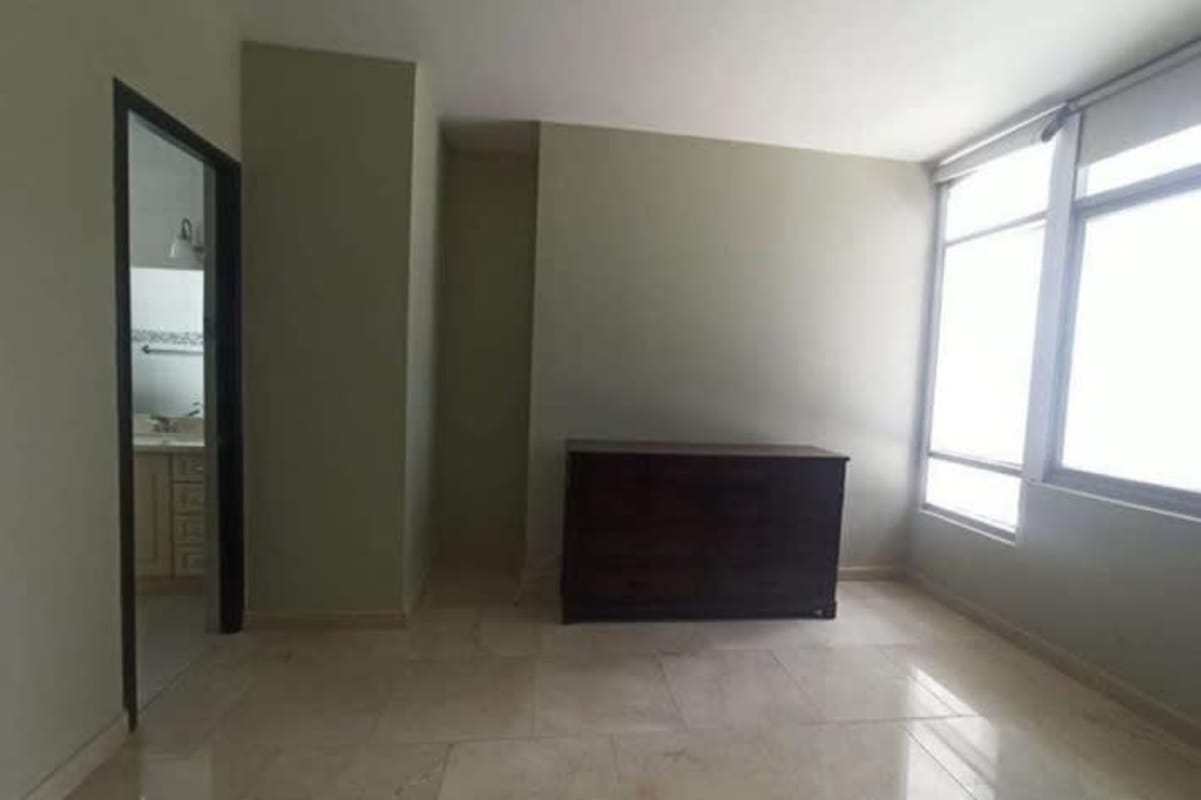 Minimalist bedroom with ocean views, large windows, bathroom, Yacht Club Tower Panama City