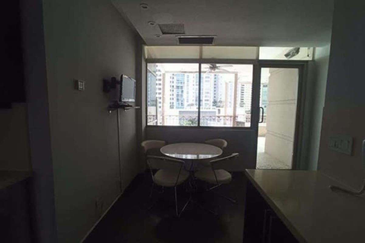 Dining space with city view, large windows and access to balcony Yacht Club Tower Panama City