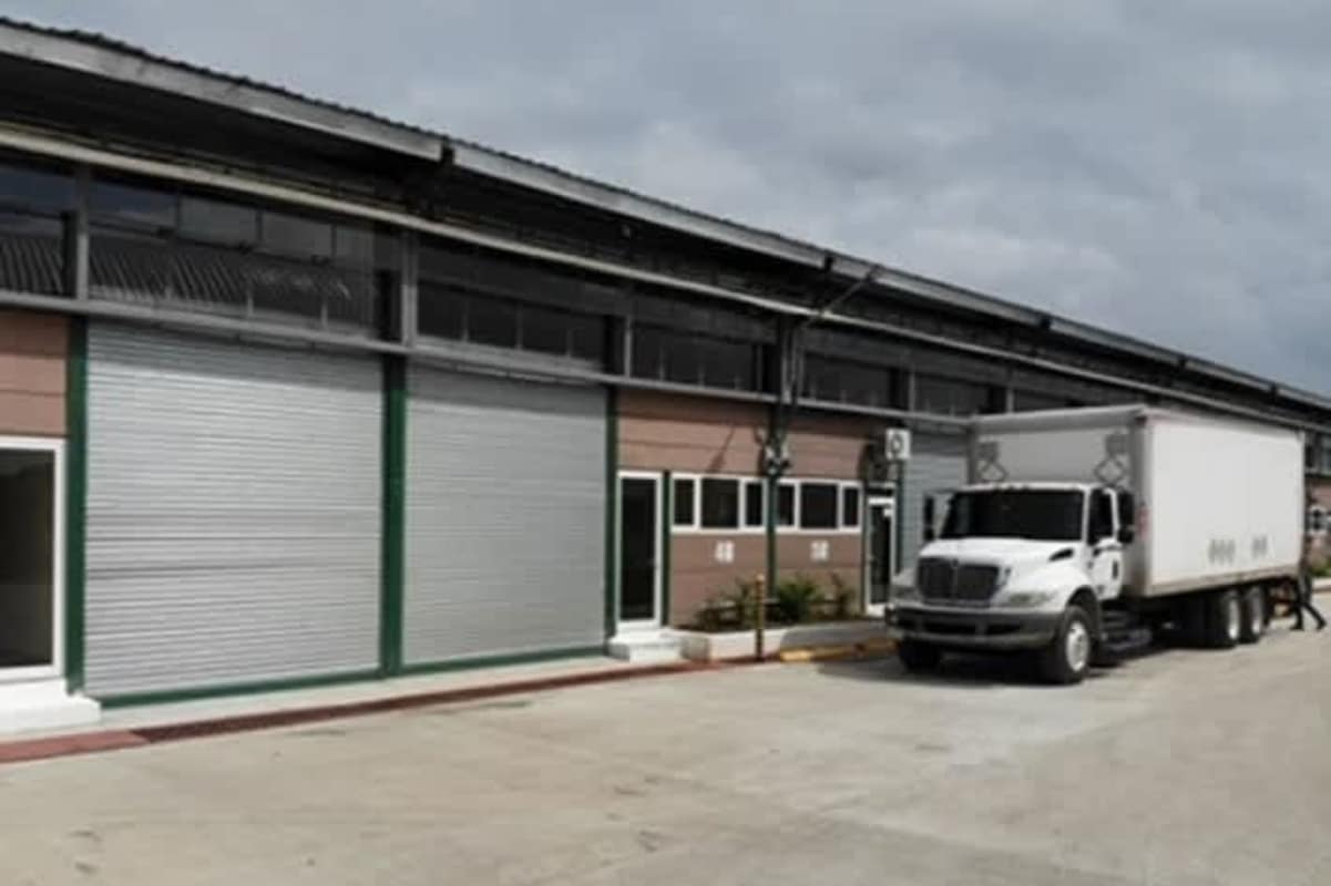 Warehouse loading bays with delivery truck and large roller doors in Villa Zaita Panama City