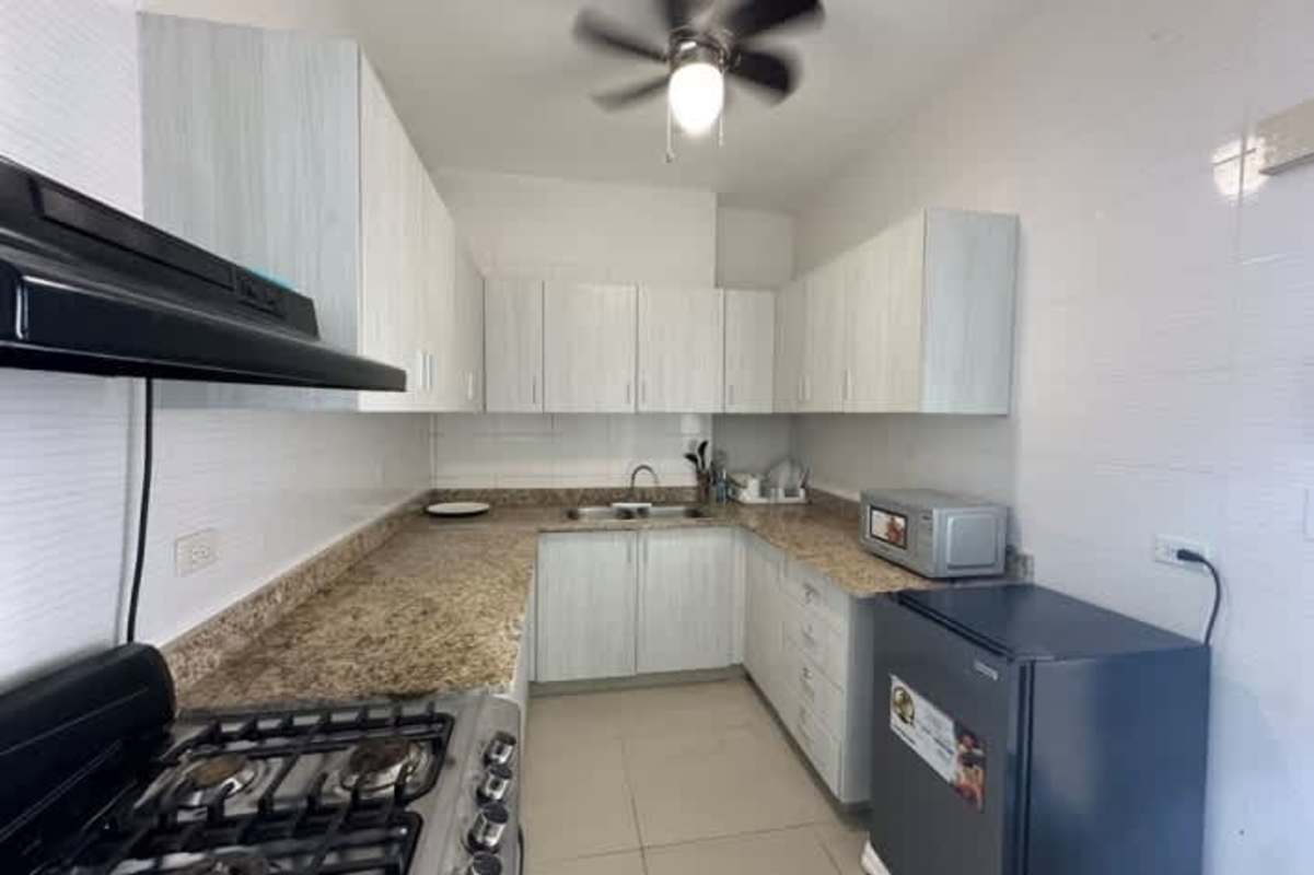 Modern open living dining room with large windows and city skyline views PH Alfa Betania Panama