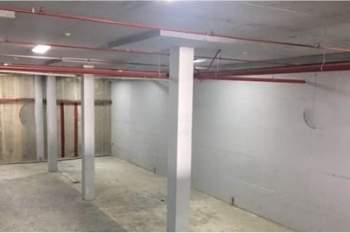 Drone view of multiple green roofed warehouses with truck bays Panama City