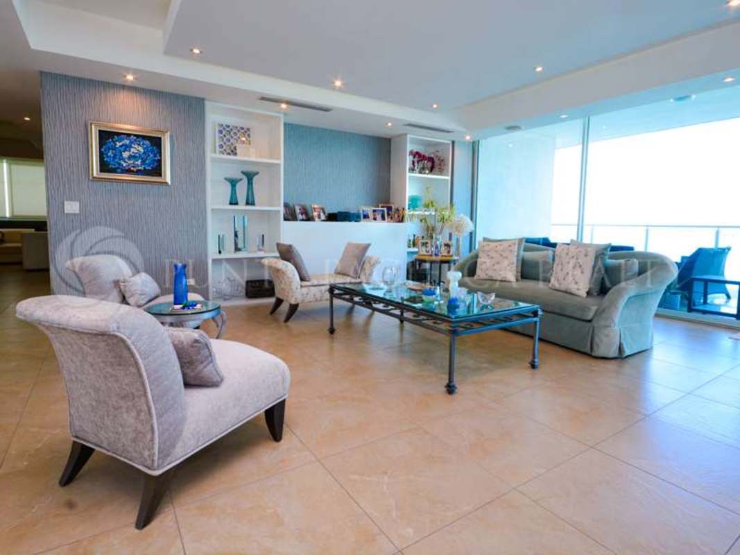 Modern open living room with large windows and ocean views in Aquamare Punta Pacifica Panama