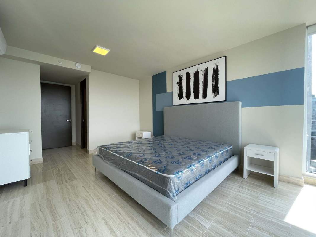 Large bedroom with balcony access and ocean views at The Regent Costa del Este Panama