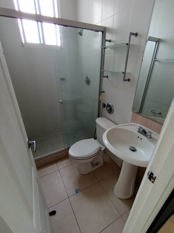 Compact bathroom with glass shower and vanity at Edison Park Panama