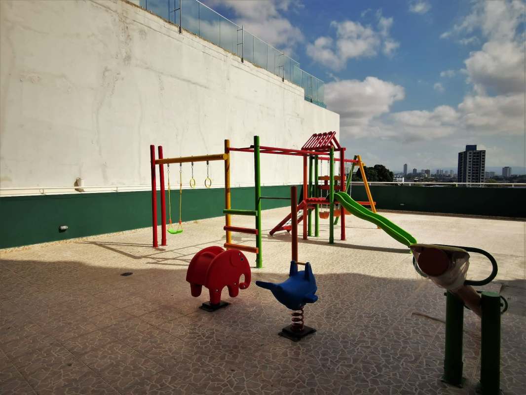 Covered terrace lounge with seating and city view at PH Edison Park Panama