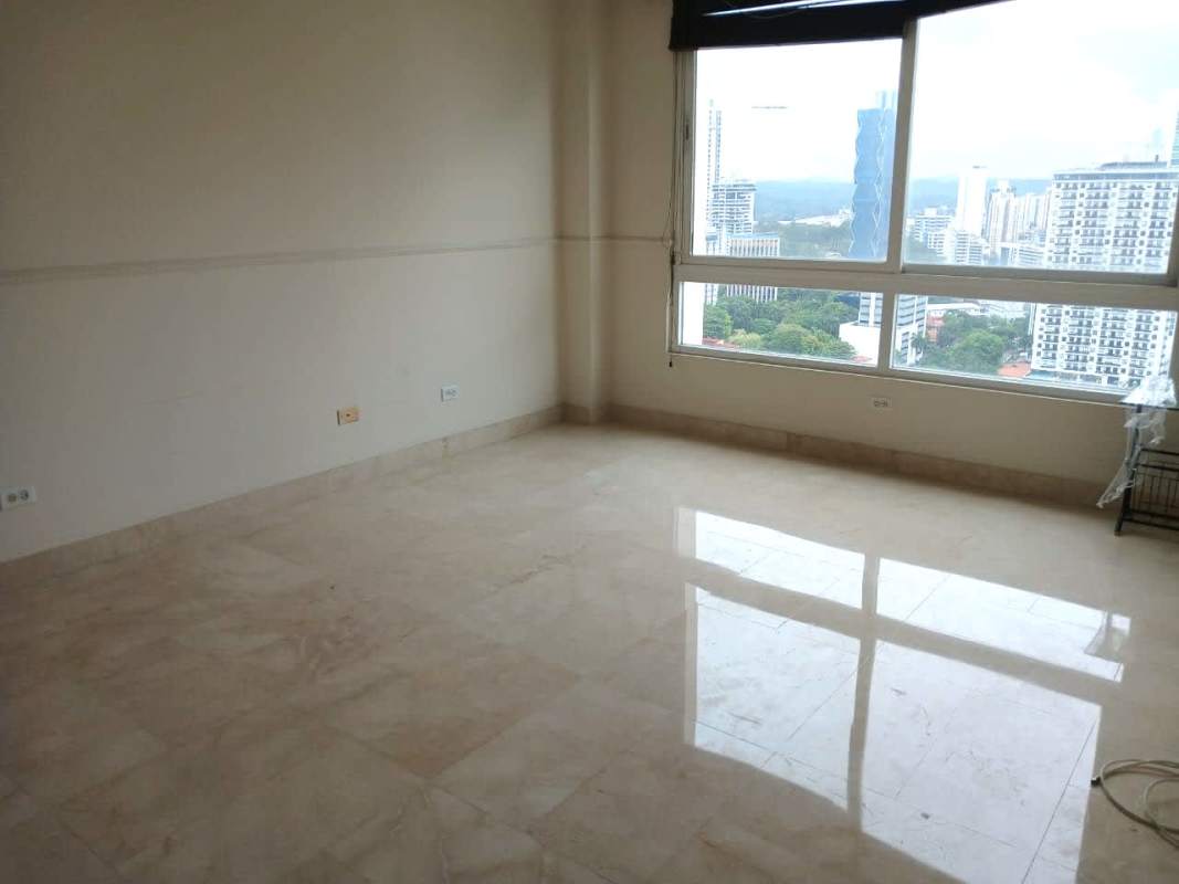 Modern living room with large window showcasing Panama city skyline at PH Vista Marina Avenida Balboa