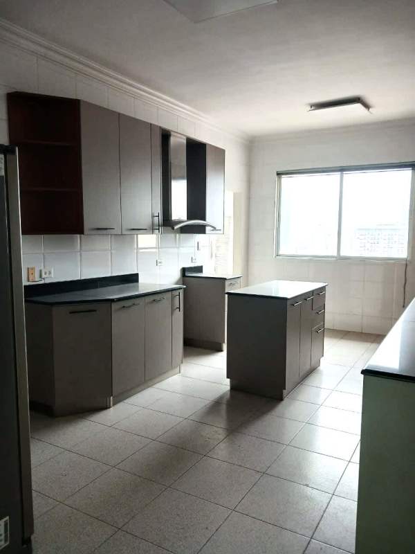 Spacious gray kitchen with central island and city view window at PH Vista Marina Panama