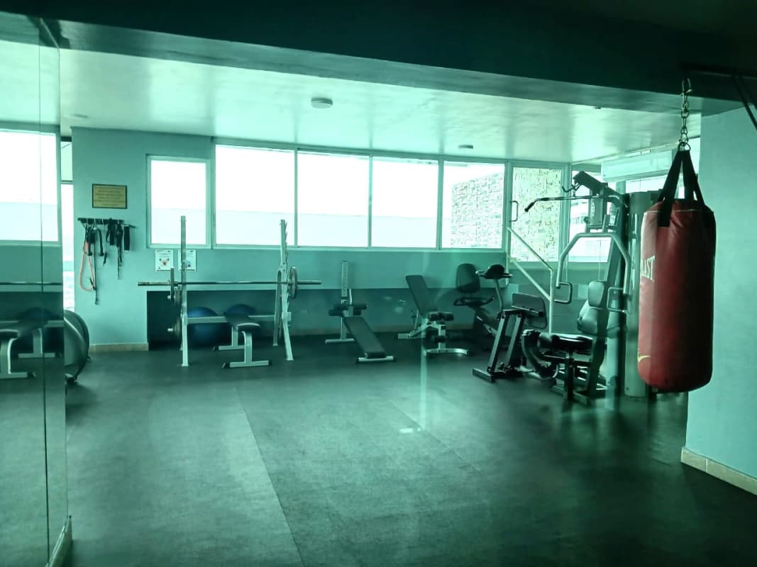 Contemporary kitchen with gray cabinets, island and city view window at PH Vista Marina Panama