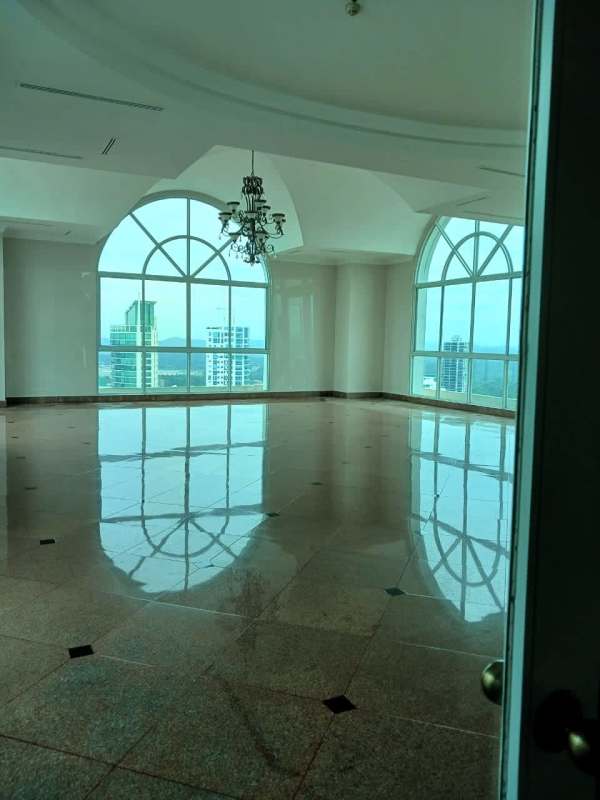 Spacious high-end living room with marble floors chandeliers and large arched windows in Vista Marina Panama