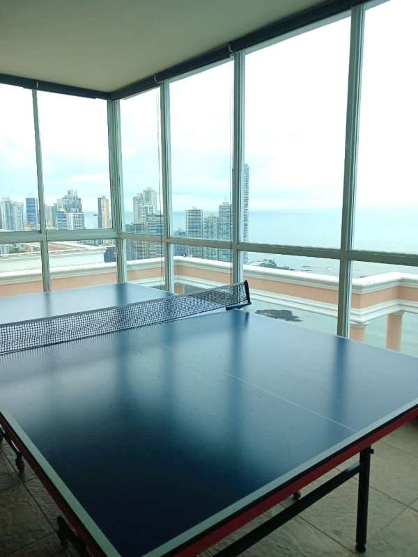 Bright recreation room featuring ping pong table and panoramic windows overlooking Panama Bay at PH Vista Marina