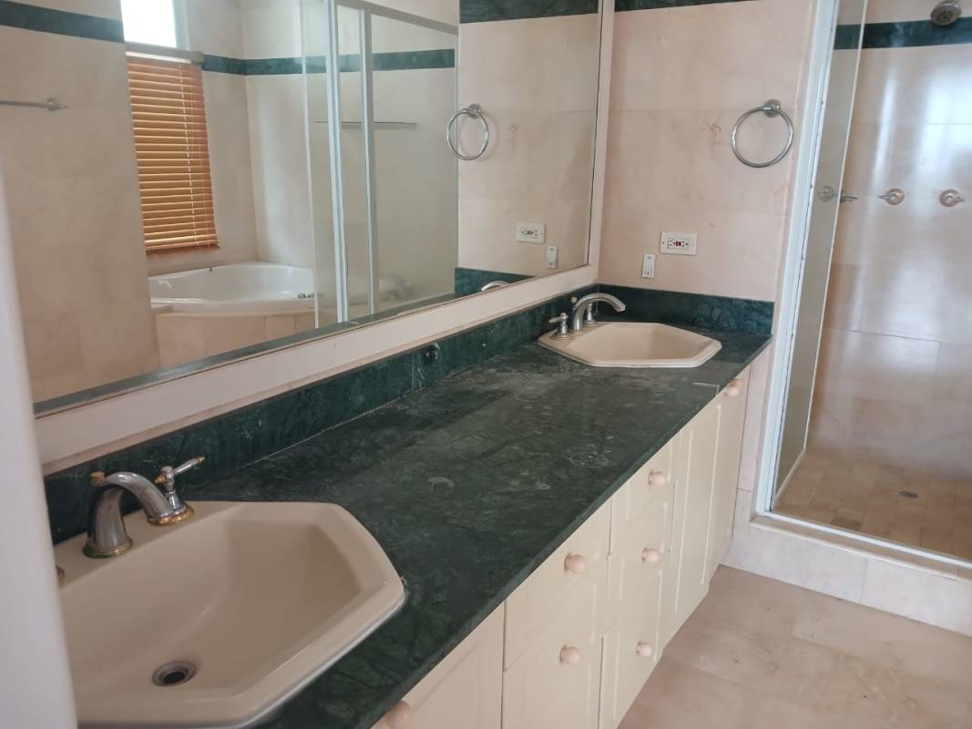 Spacious master bathroom with double vanity, green marble counters, glass shower and jetted tub in PH Vista Marina