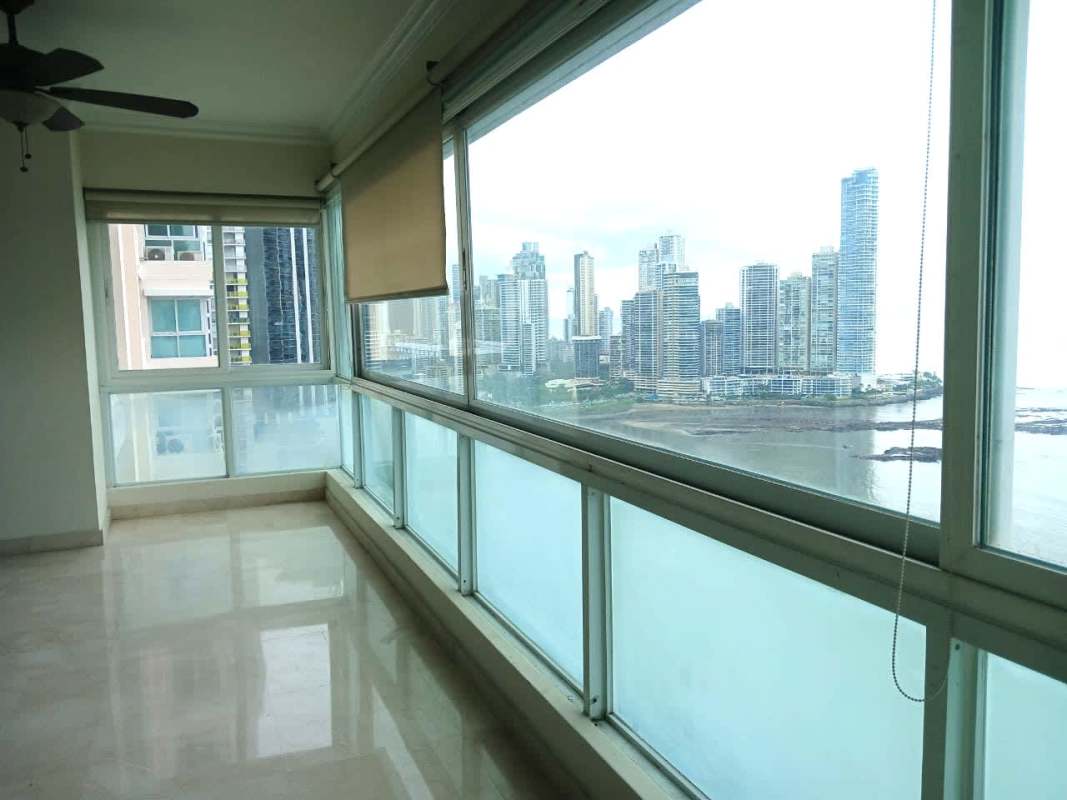 Bright sunroom enclosed balcony with floor-to-ceiling glass offering Panama Bay views at PH Vista Marina