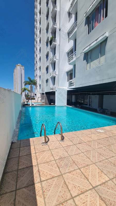 Outdoor swimming pool beside high-rise PH Plaza Valencia on Vía España Panama City