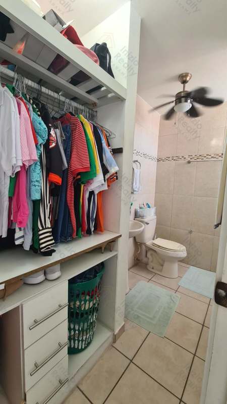 Walk-in closet space with bathroom tiled walls PH Plaza Valencia Panama