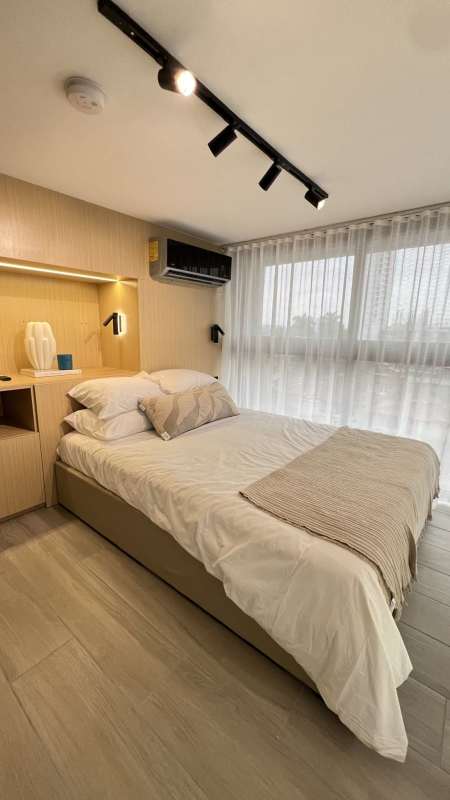 Minimalist bedroom mezzanine floor, large window with city views PH Arcadia Coco del Mar