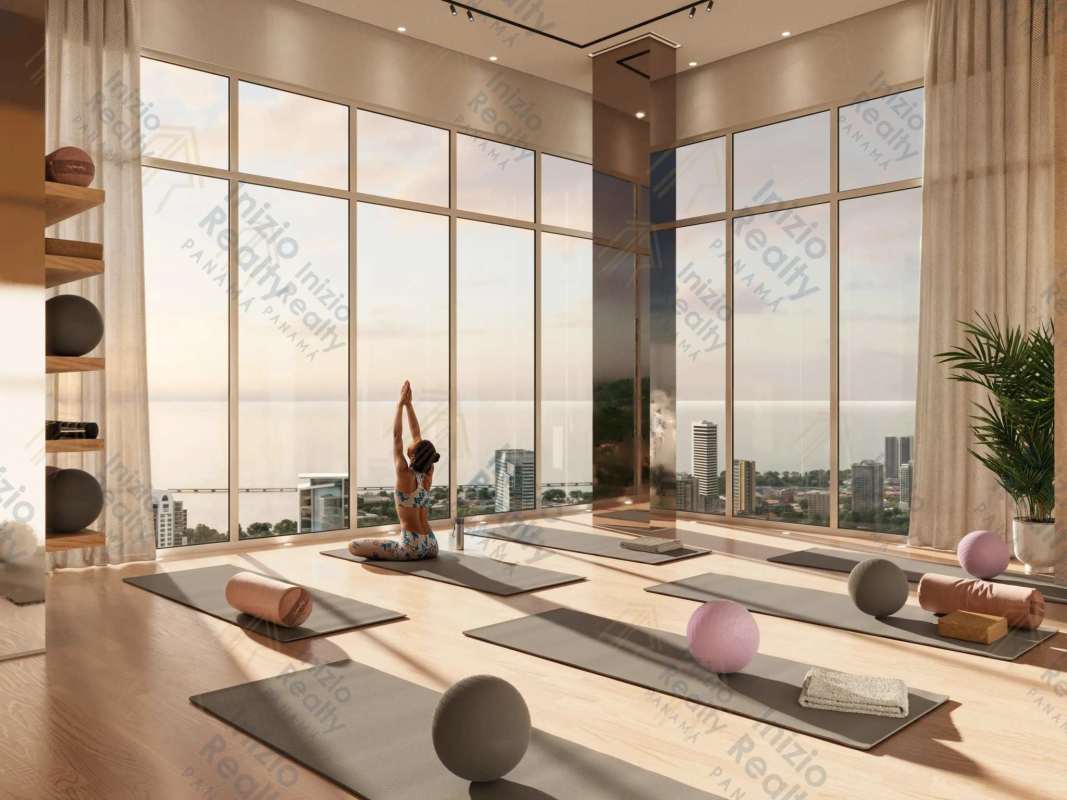 Yoga studio with floor-to-ceiling windows panoramic ocean and skyline view at Avenida Balboa Panama