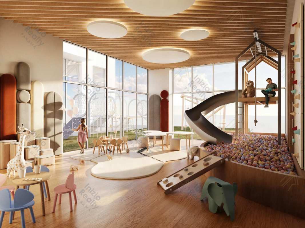 Bright kids playroom indoor slide climbing wall floor to ceiling windows at PH Costanera Towers Panama City