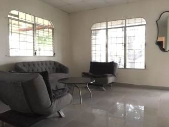 Traditional kitchen with island tile counters wood cabinetry stainless appliances Santiago Panama