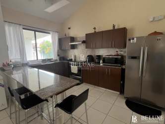 Spacious kitchen with granite island, wood cabinetry and appliances at Piedras Gordas Village beach house San Carlos Panama