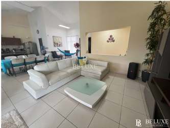 Master bedroom with large window, natural light, neutral decor and ensuite bathroom in Piedras Gordas Village San Carlos Panama