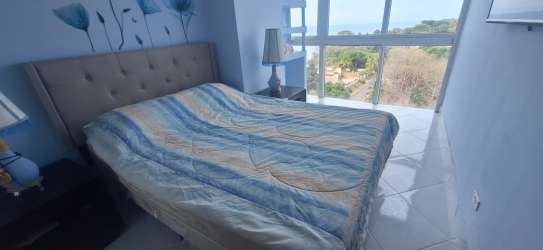 Living room with sectional sofa, ocean view windows and dining table PH Ibiza Playa Corona Panama