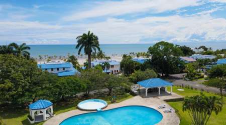 Large living space with sectional sofa, tile floors and ceiling fans at Playa Blanca villa