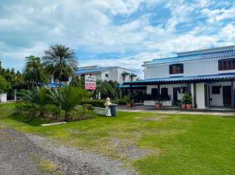 Bright dining area with ceiling fan and arched doors open to patio in Playa Blanca Panama