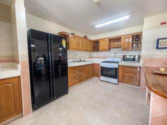 Traditional kitchen with wood cabinets, granite counters and appliances Playa Blanca villa