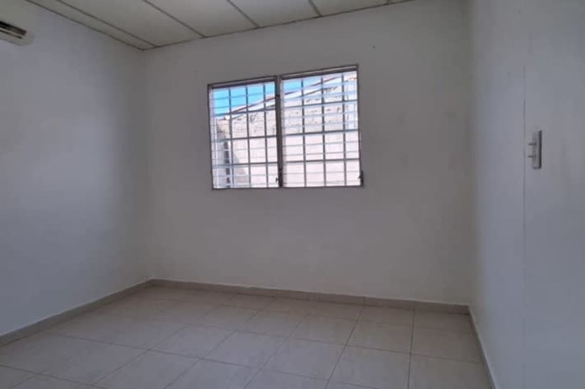 Empty bedroom with AC, tiled floor, barred window in Don Bosco house for sale