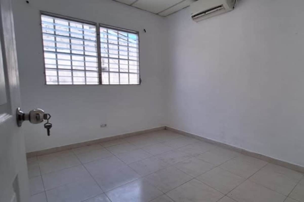 Empty minimalist bedroom with tiled floors and barred windows Don Bosco Panama