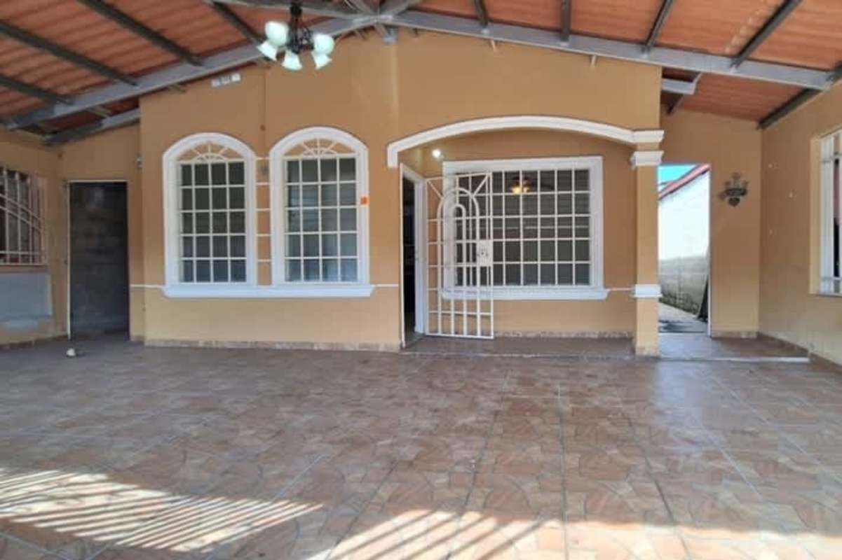 Covered porch area with security bars and tiled floors at Don Bosco house for sale