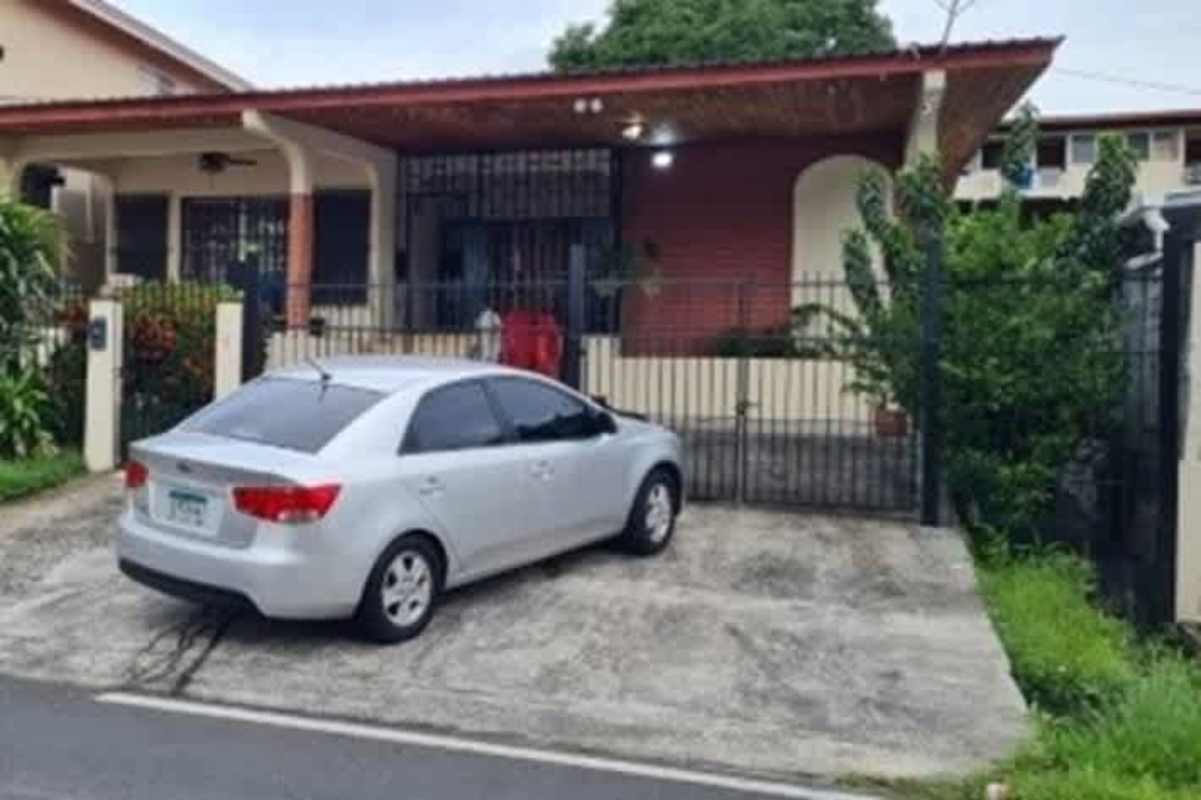 Gated driveway with parking silver car Betania Panama house for sale