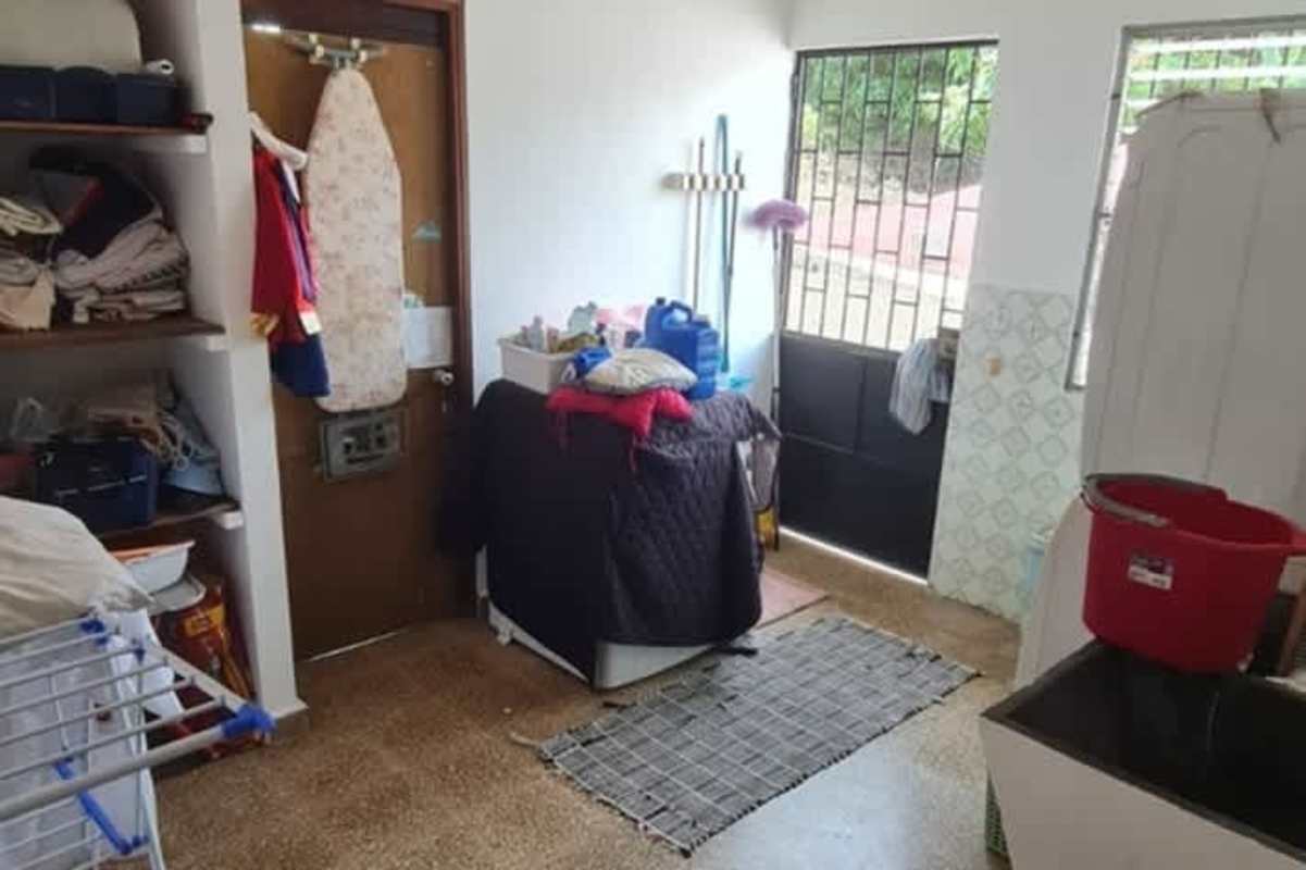 Laundry utility room with washer sink patio exit Betania house