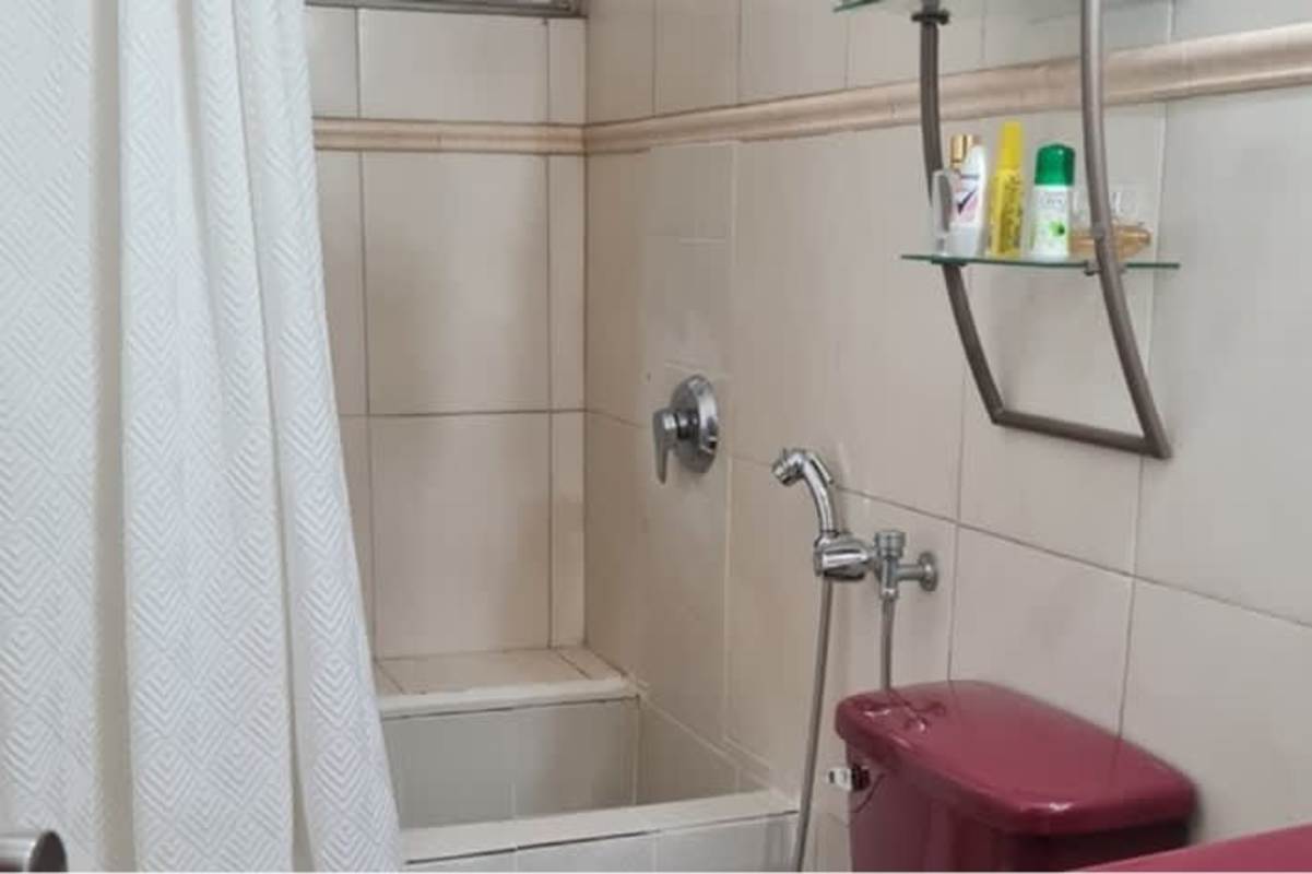 Functional bathroom with beige tiles shelves toilet Betania Panama