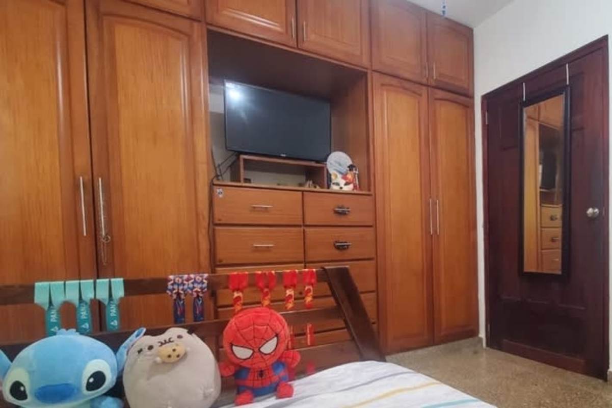 Bedroom with large wooden wardrobe TV Betania Panama house interior