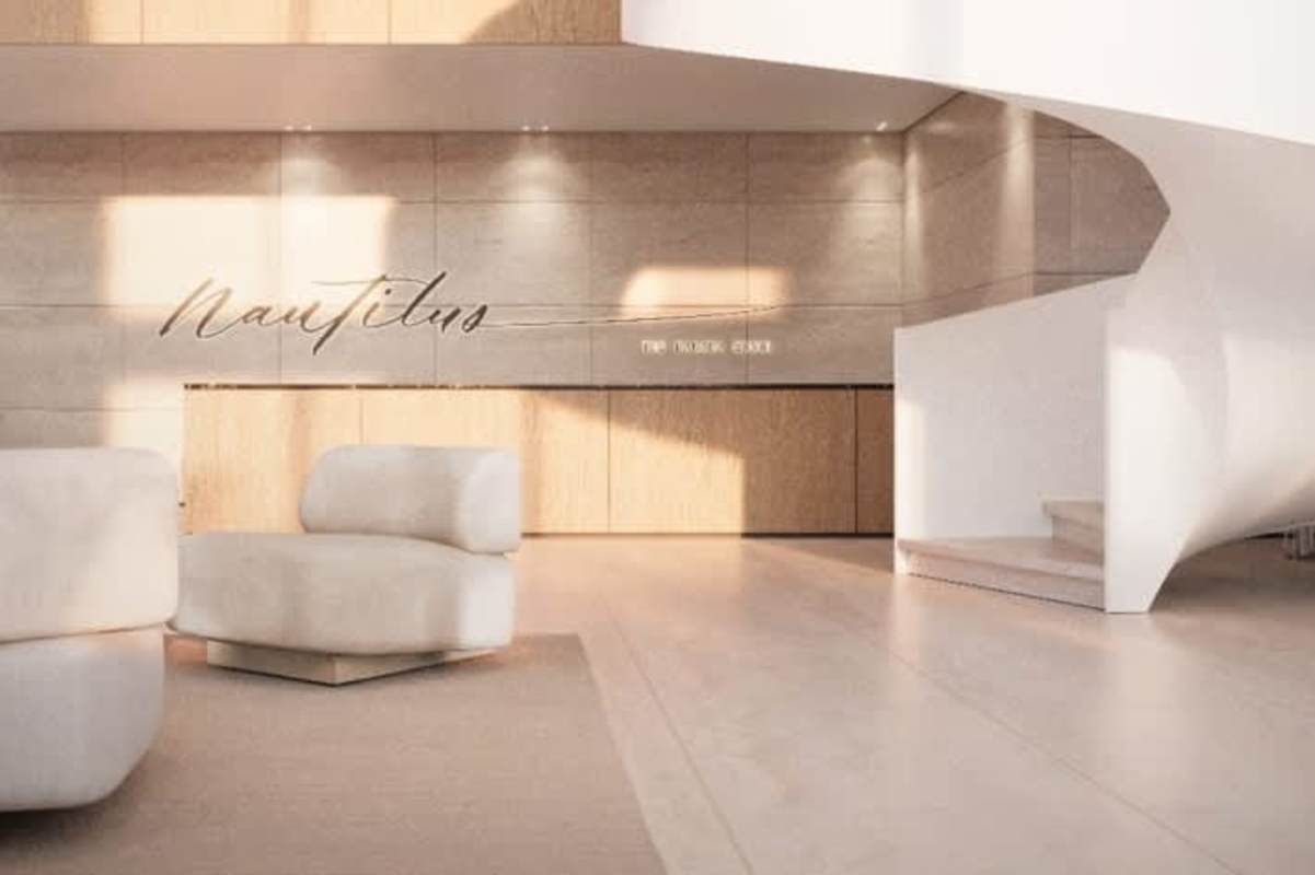 Minimalist lobby with curved stairs, wood finishes and Nautilus signage at Amador Panama