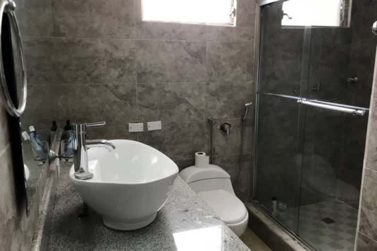 Contemporary bathroom with glass shower vessel sink granite countertop Punta Paitilla Panama