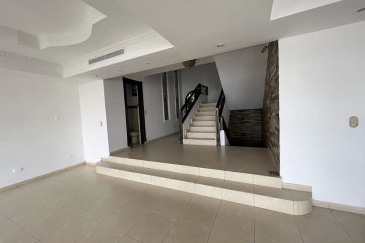 Contemporary kitchen with dark cabinetry, granite countertops, large windows in Dos Mares Panama City