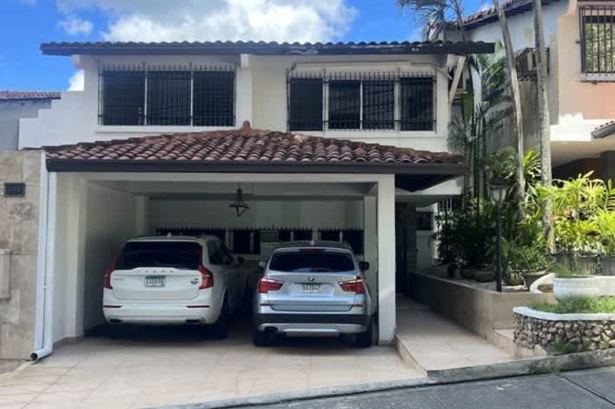 Spacious living room with tile floors, double height ceilings, staircase, and large windows Dos Mares Betania Panama