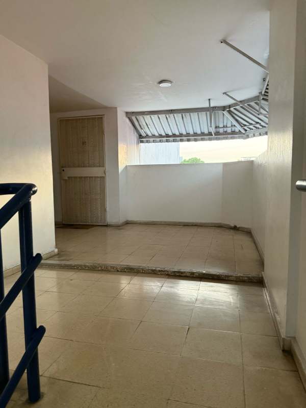 Corridor entrance with metal door and window awning at Beverly Plaza Rio Abajo Panama