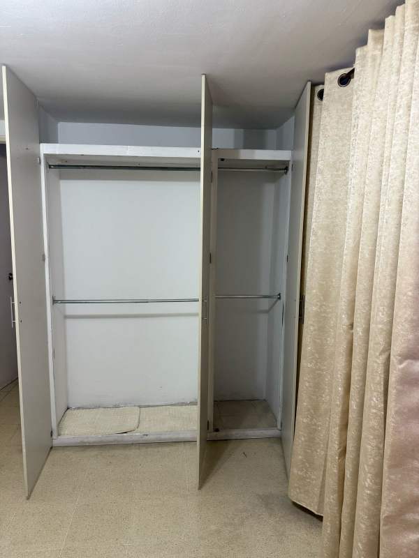 Bedroom space featuring wardrobe and curtains in Beverly Plaza Rio Abajo Panama City