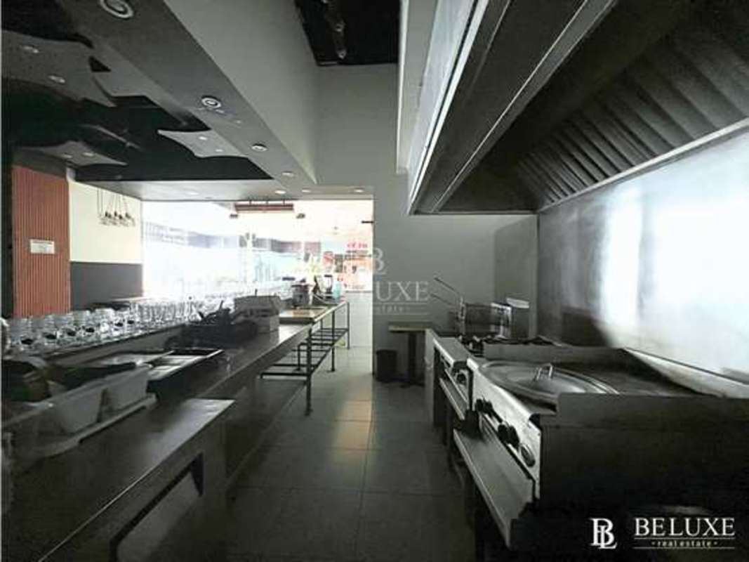 Professional kitchen with stainless steel appliances, large exhaust hood in Coronado Restaurant Panama City