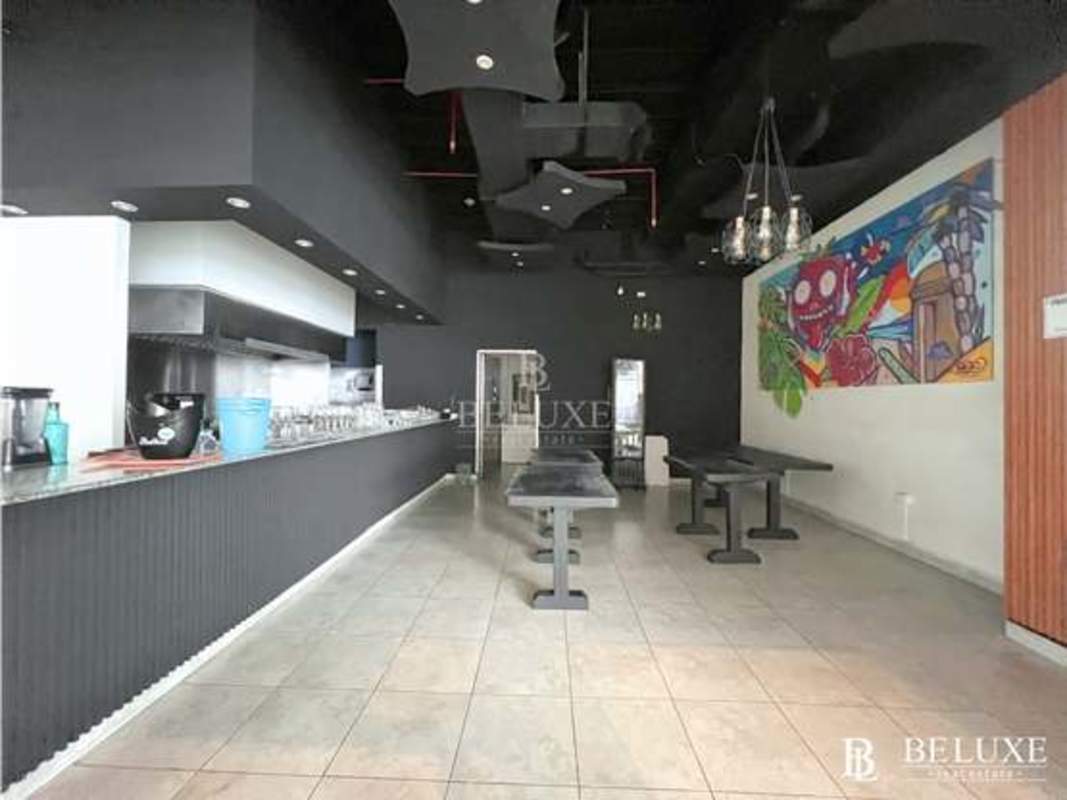 Contemporary industrial chic restaurant dining open kitchen pendant lighting Avenida Balboa Panama