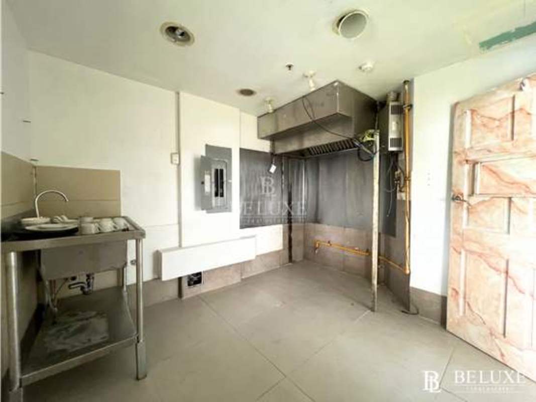 Empty industrial kitchen area with stainless fixtures and ventilation, Panama City