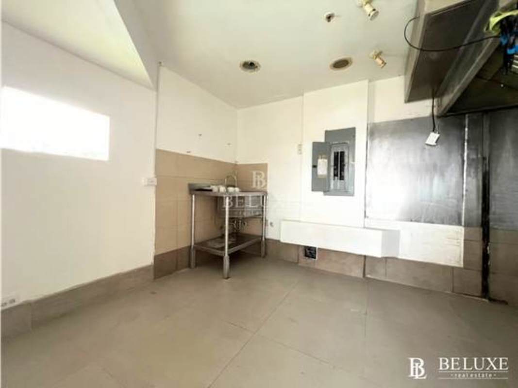 Empty commercial kitchen stainless backsplash and utility wall, Panama City commercial space