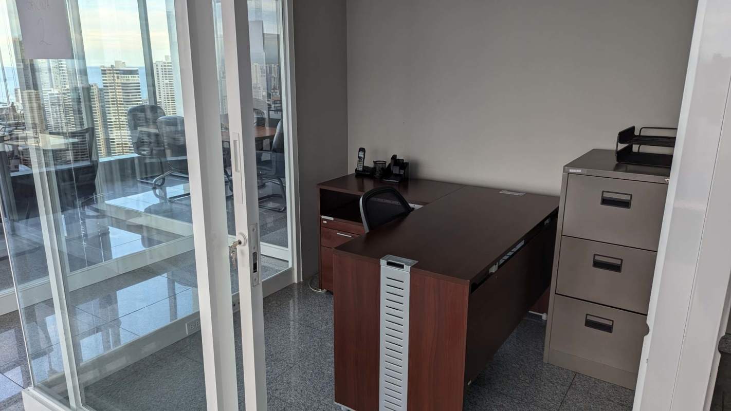 Glass-walled private offices at PH BICSA with skyline and ocean panoramas