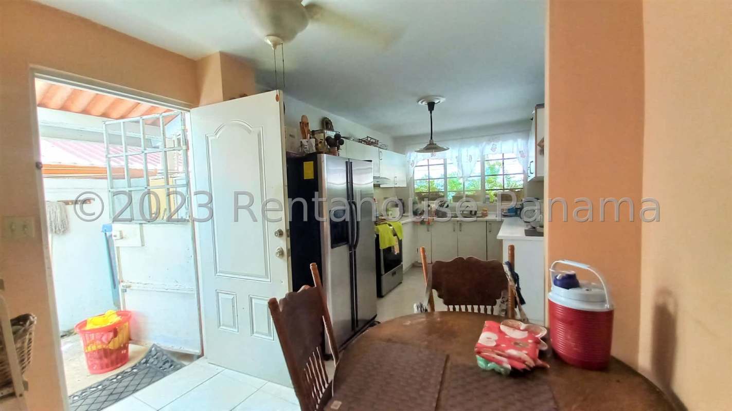 Kitchen with white cabinets stainless refrigerator window tile floor PH Villa Lido Panama
