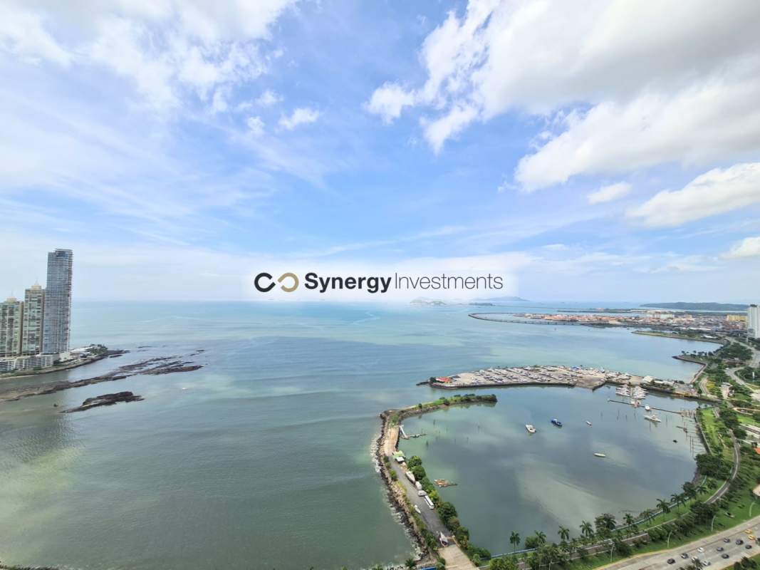Living and dining room with balcony offering ocean and city views PH Vista del Mar Panama City