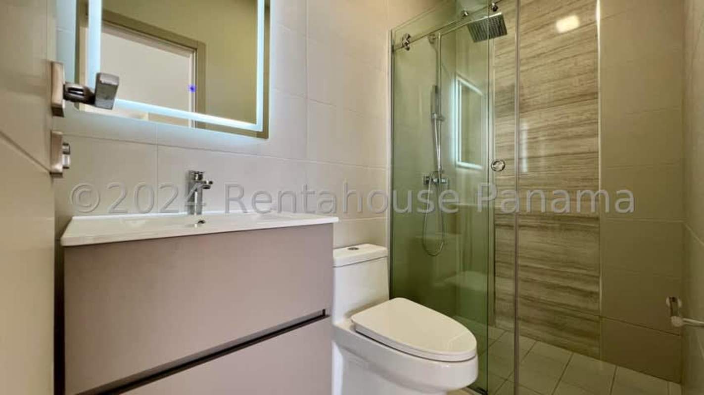 Modern bathroom with glass shower enclosure and illuminated mirror PH Paramount Costa del Este Panama